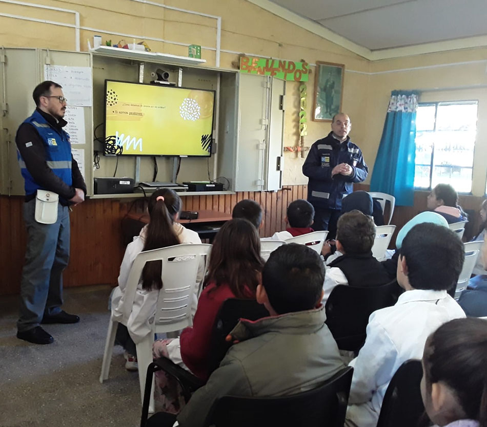 Mayo Amarillo en Tranqueras 7 Dos inspectores de tránsito frente a una pantalla con la presentación de Mayo Amarillo, ante escolares en un salón de Tranqueras